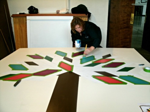 Citizens bank Volunteer help to paint their mural Tree of Life