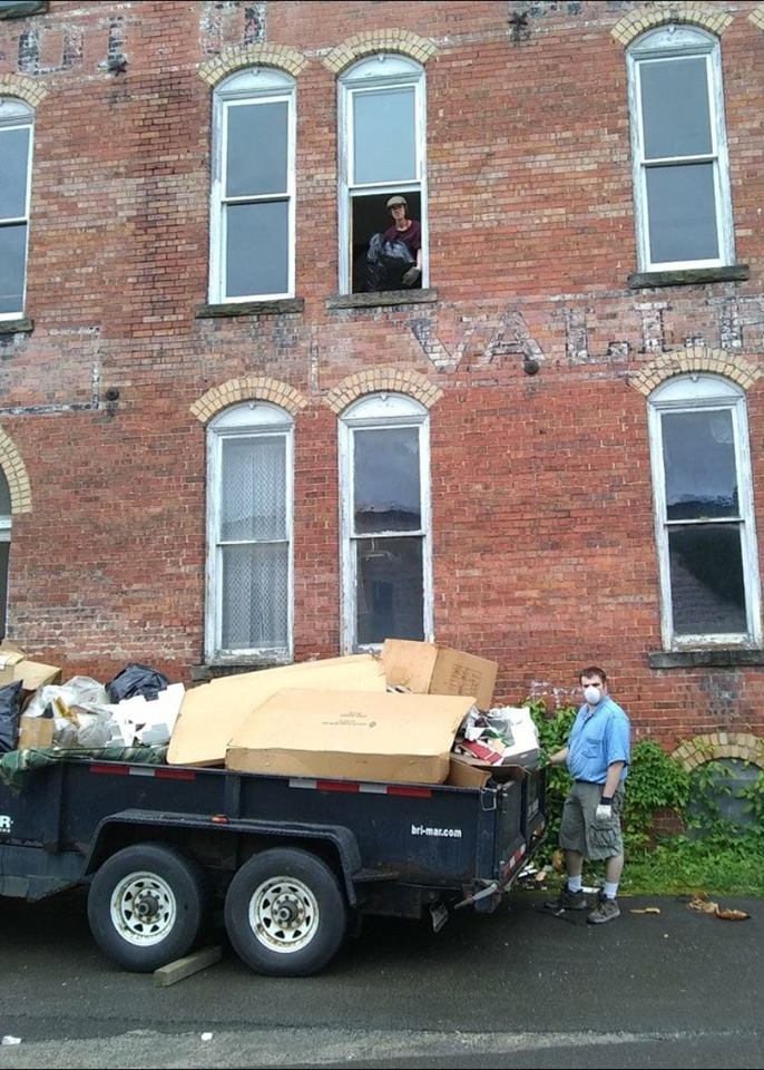 logan and Patrick AmeriCorps members volunteer to toss out 4,000 pounds of trash