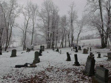 view of headstones in the snow