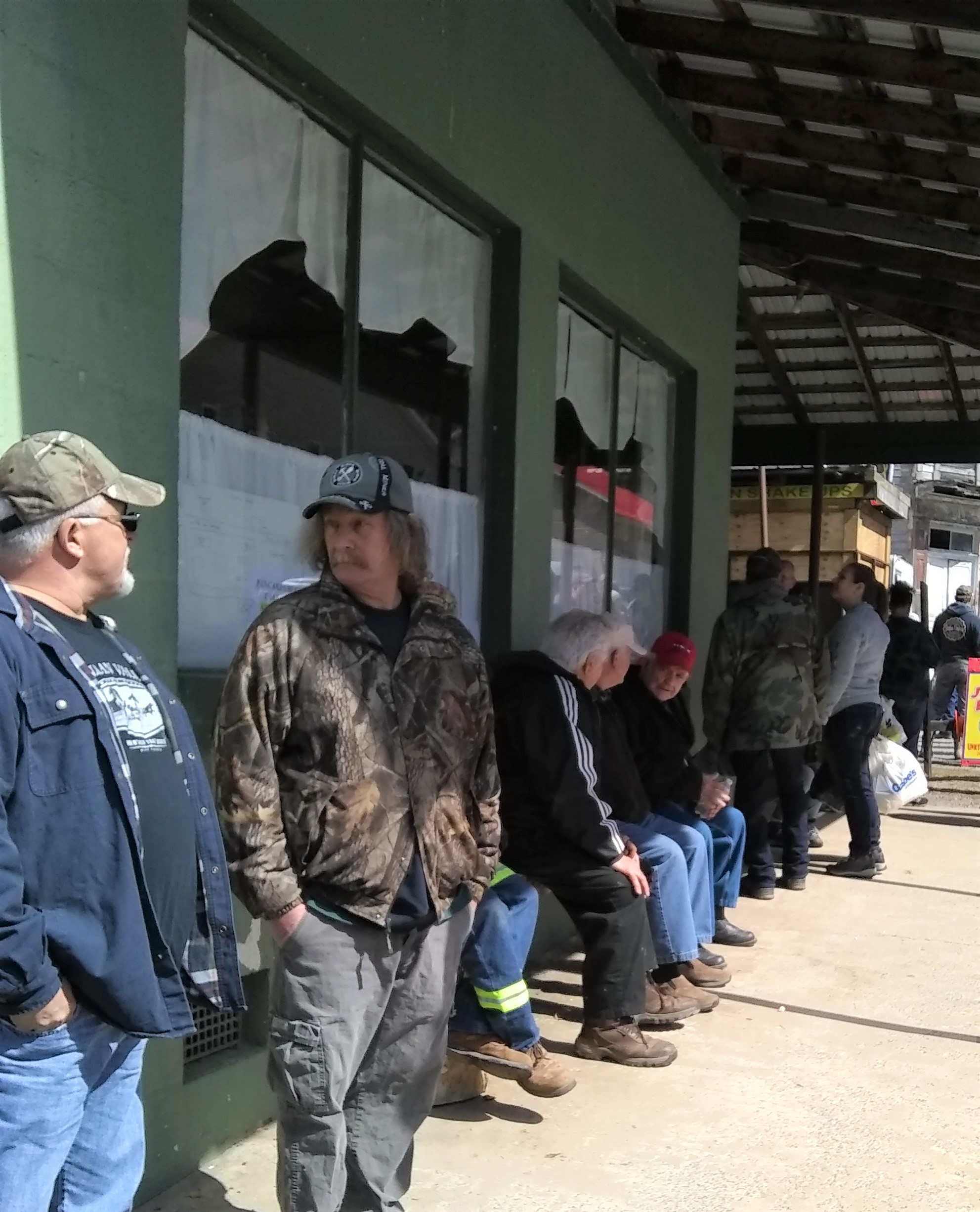 old men visit on porch at the Maple syrup festival